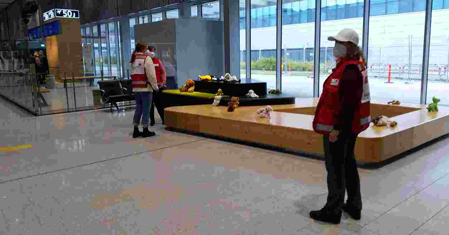 Three Red Cross volunteers at the airport