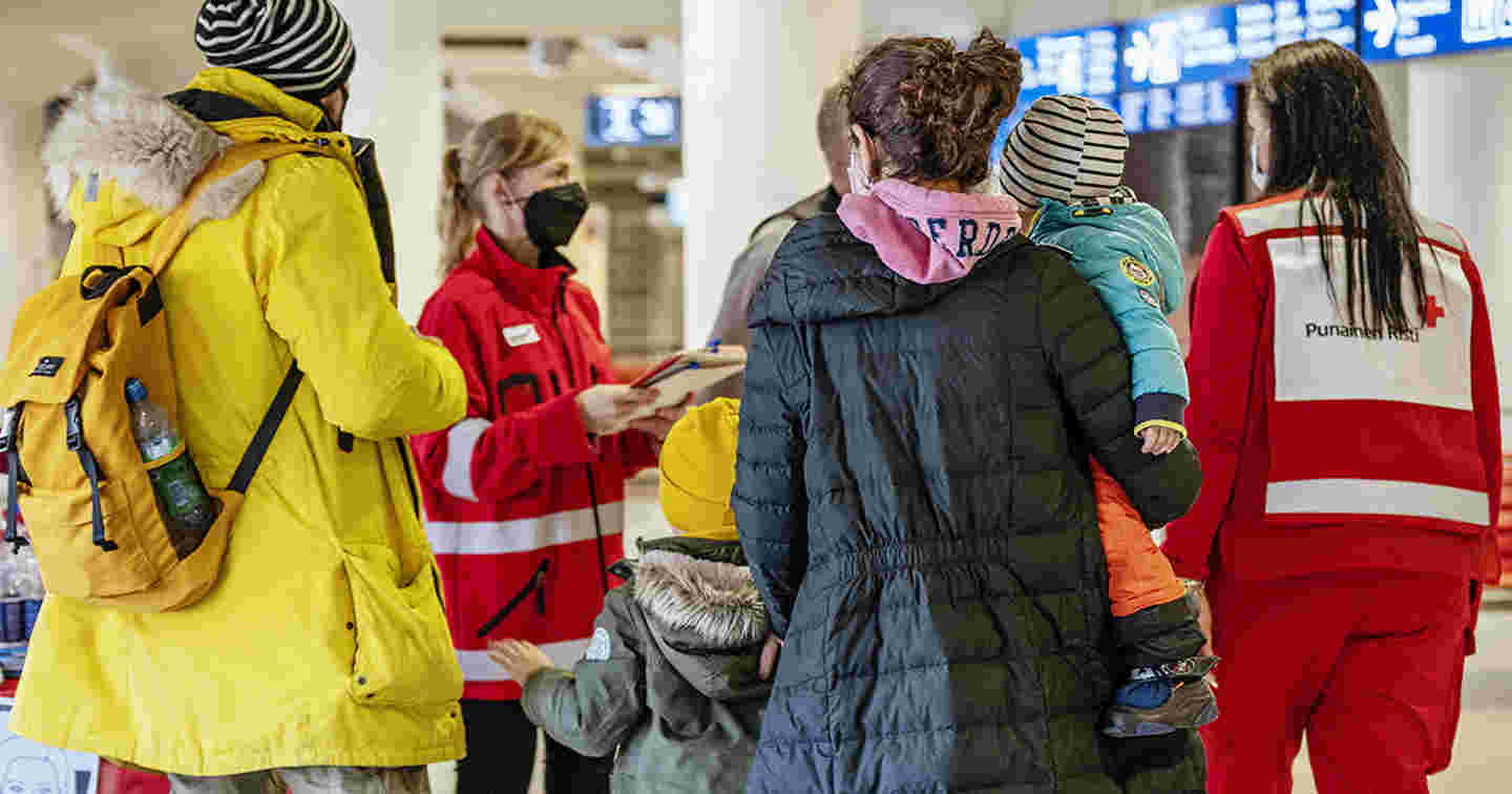 Red Cross volunteers and employees receiving people fleeing the Ukraine conflict at Helsinki’s West Harbour.