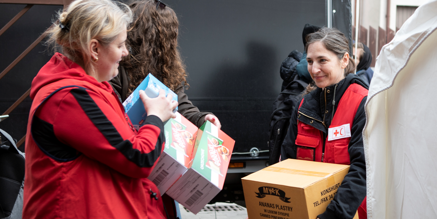 Jenelle from the International Federation of Red Cross and Red Crescent Societies is helping to unload an aid shipment in Warsaw, Poland.