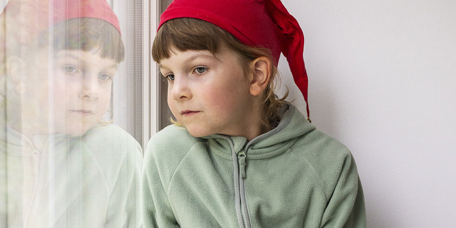 A child is looking out of the window.