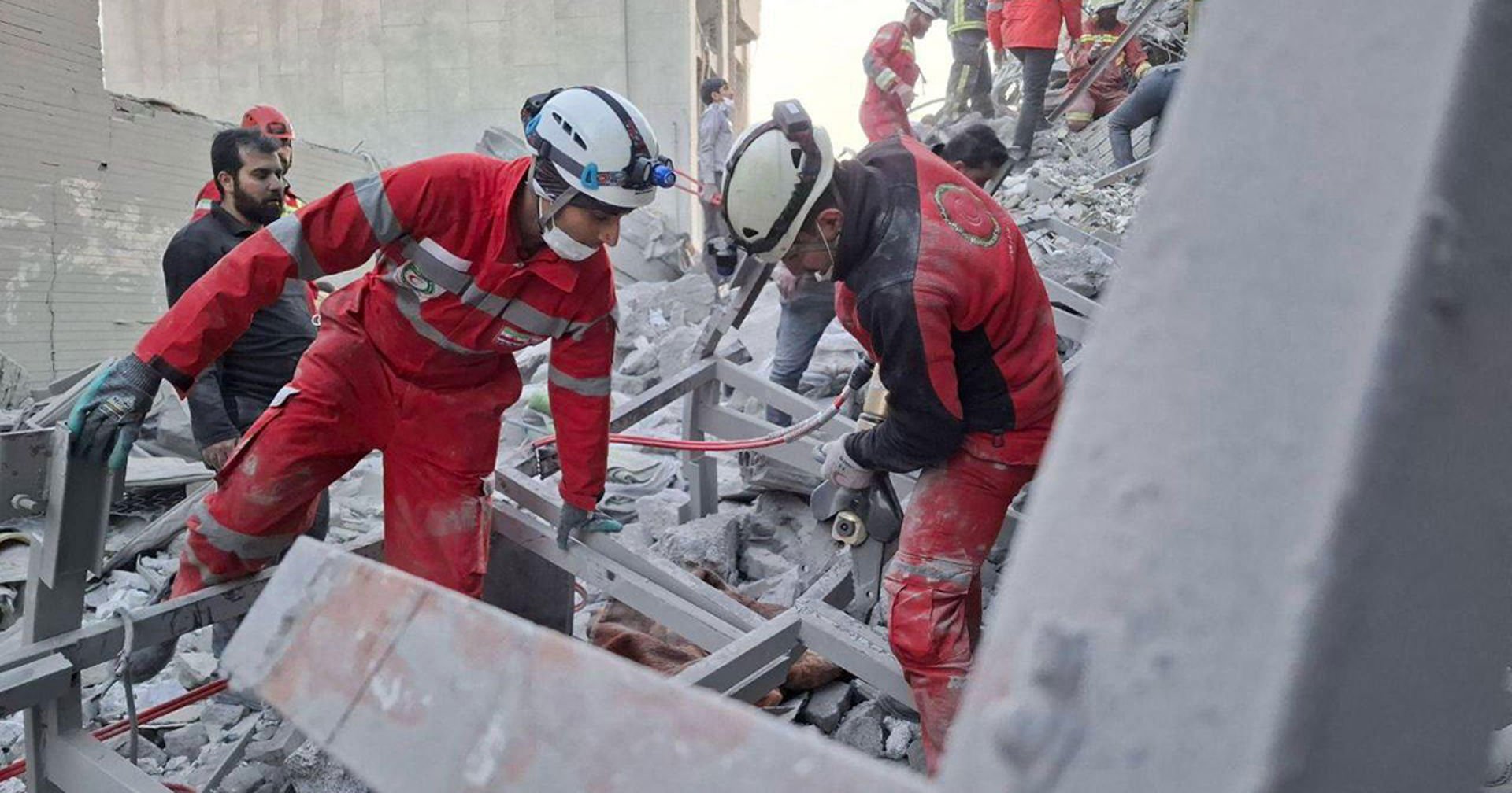 Iranian Red Crescent volunteers save the injured, provide first aid and clear up debris. A team in the ruins of a school building in Minab in the Hormozga province on 27 February. 
