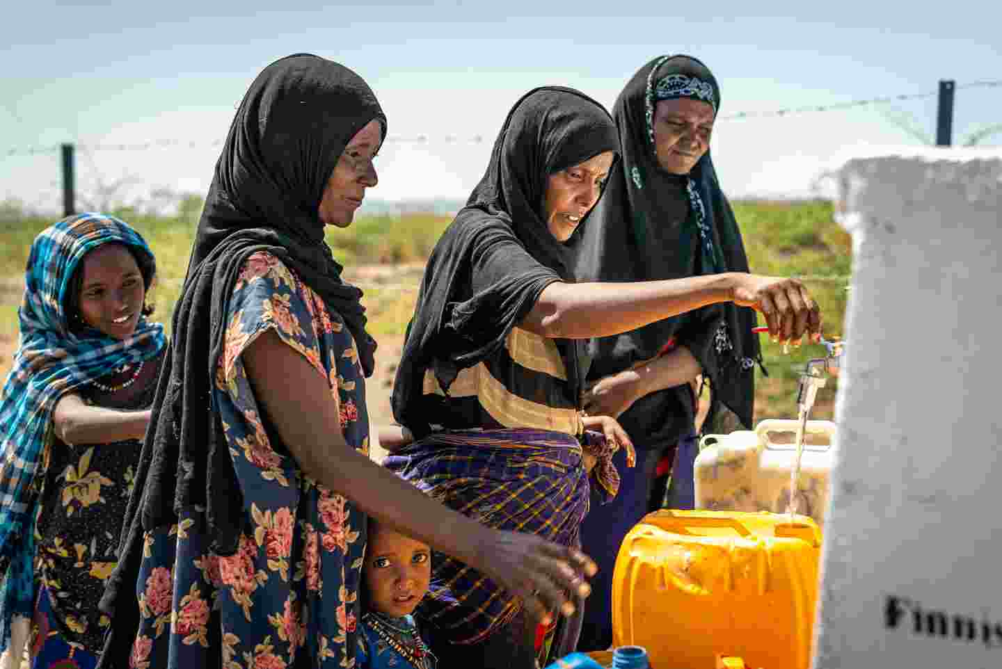 African women getting water for canisters.