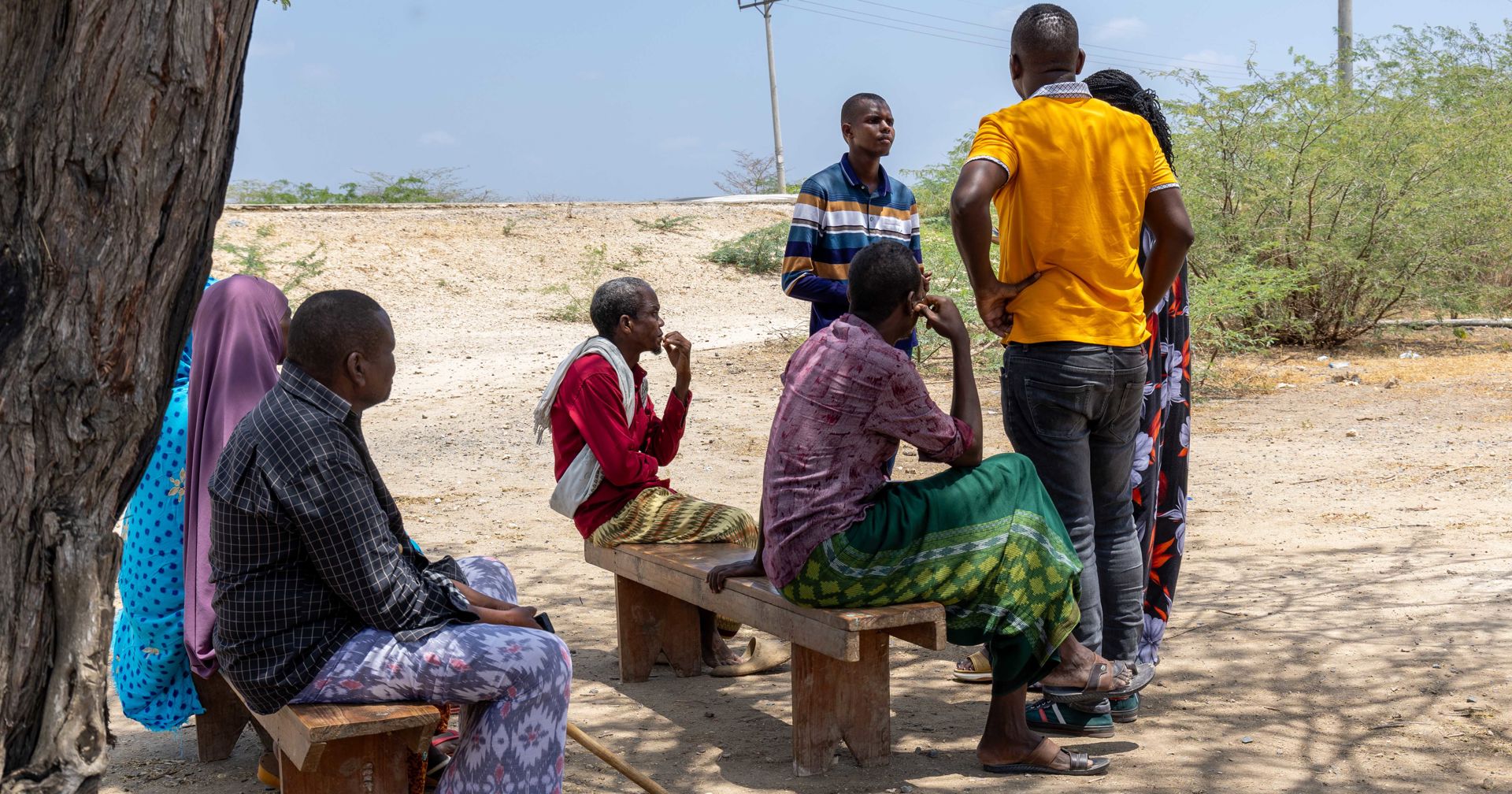 Guyo Godana Yusuf talks to several representatives of his community in the shade of a tree in Turkana.