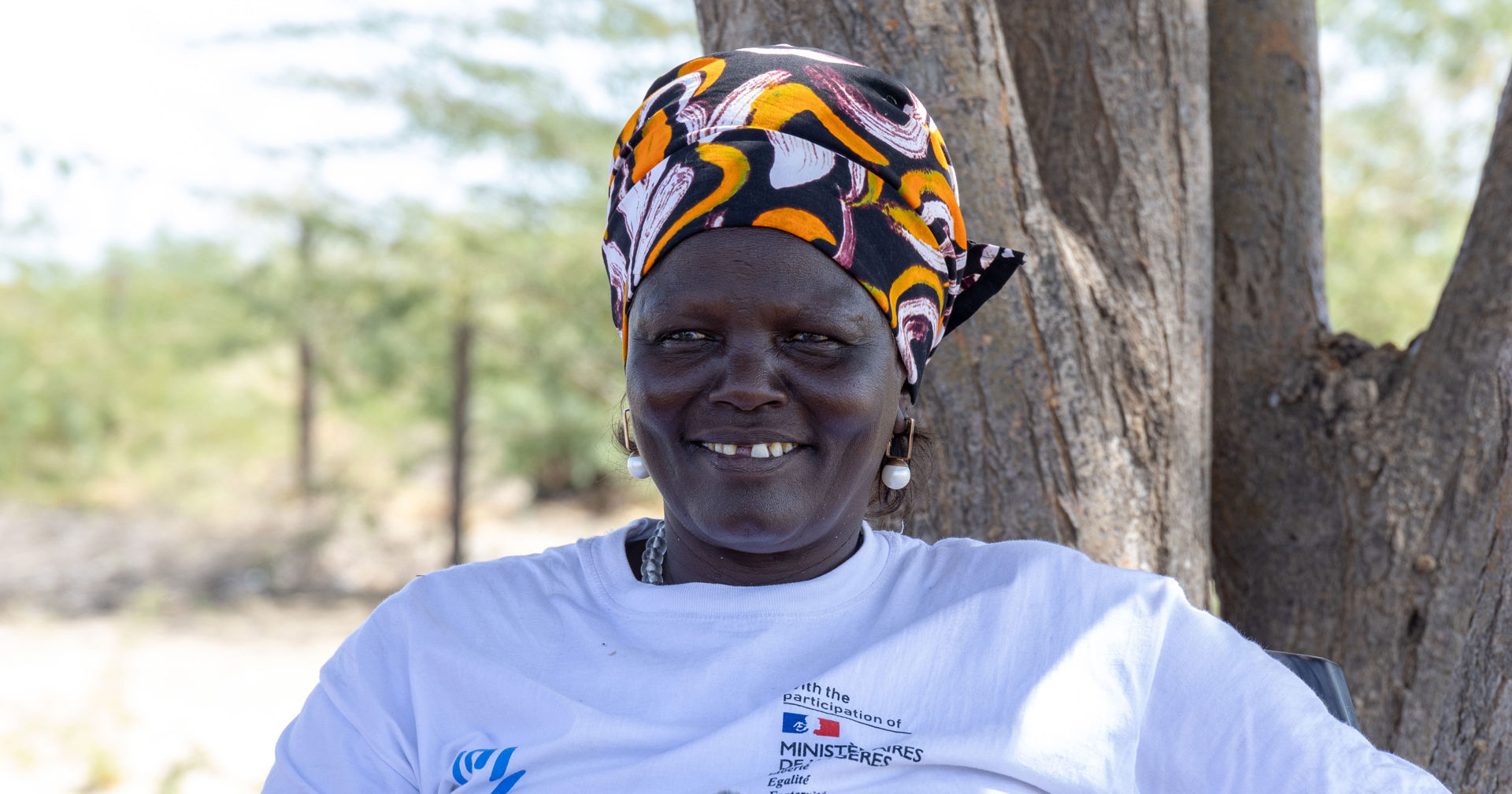 Mary Ataba smiles and looks at the camera.