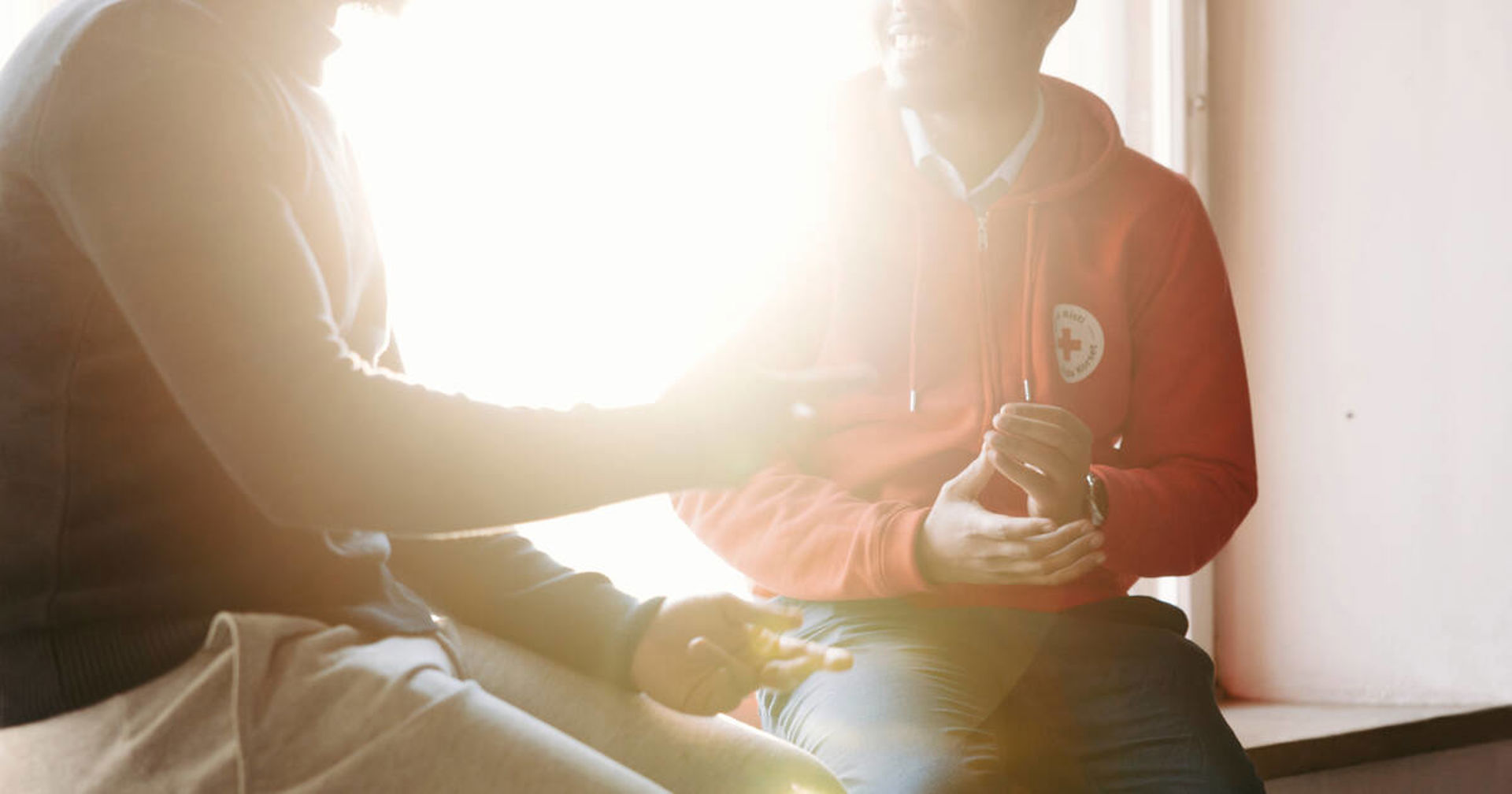 Three young immigrant men in a sunny park in autumn.