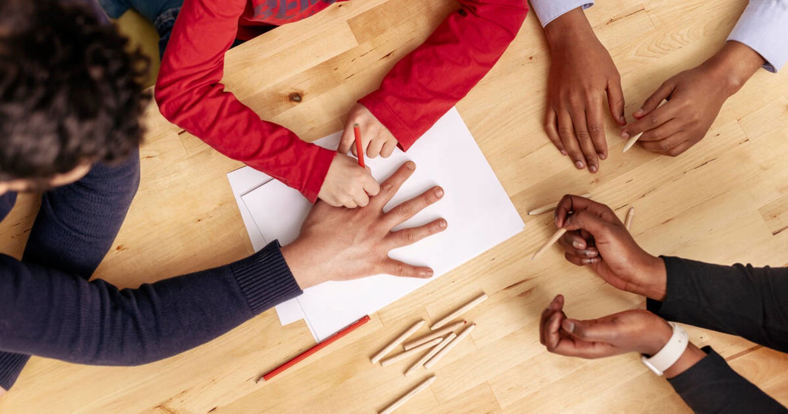 Dozens of people holding balloons in an anti-racism event in a market square.