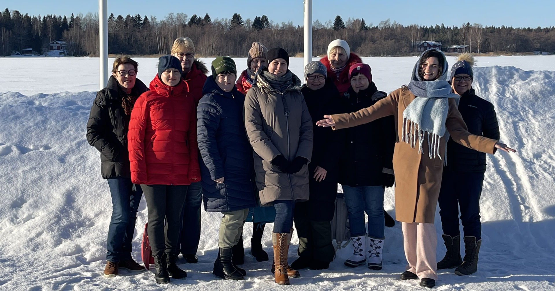 Red Cross volunteer and participants of the Red Cross course in Ukrainian smiling together outdoors in the winter.