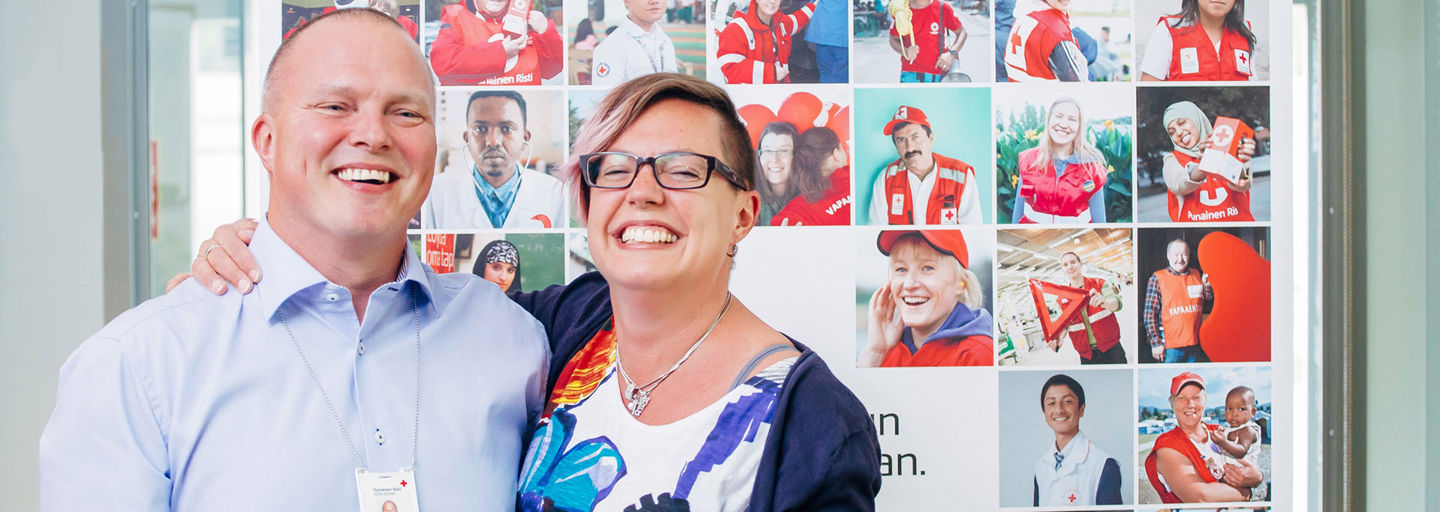 Two smiling Red Cross employees.