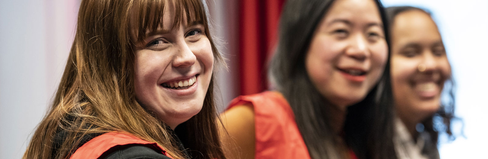 Four Red Cross volunteers putting up a tent in sunny weather